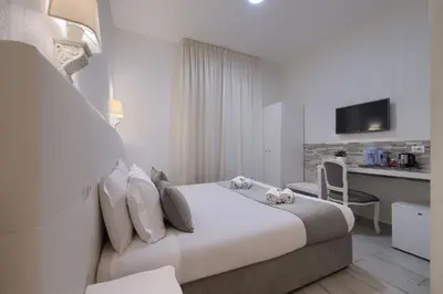 a hotel room with a bed and a kitchen at Vatican Tourist Inn in Rome