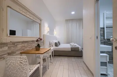 a hotel room with a bed and a table and chairs at Vatican Tourist Inn in Rome