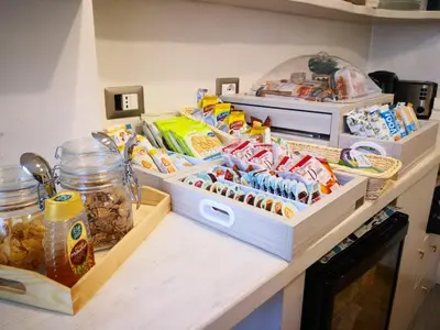 a kitchen counter with three boxes of food on it at Landlord in Trastevere in Rome
