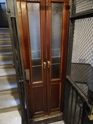 a pair of wooden doors in a building at Landlord in Trastevere in Rome