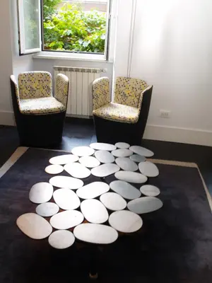 a room with two chairs and a circle rug at Vatican Modern Apartment in Rome
