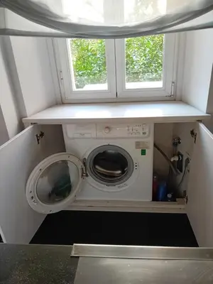 a washing machine in a small room with a window at Vatican Modern Apartment in Rome