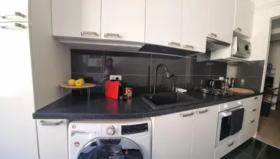 a kitchen with a washing machine and a sink at B&B Vaticanrooms in Rome