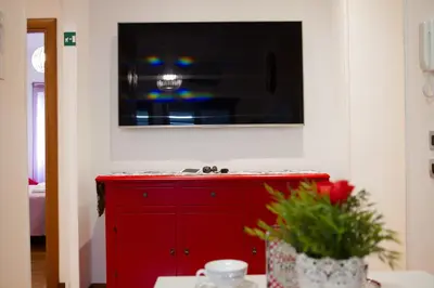 a red cabinet with a television on top of it at La Casa Del Pigneto in Rome