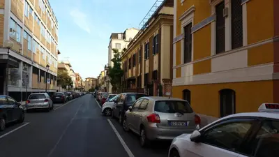 a street with cars parked on the side of the road at La Casetta di Ely in Rome