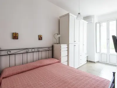 a bedroom with a bed and a dresser and a window at Apartment Il Piccolo by Interhome in Rome