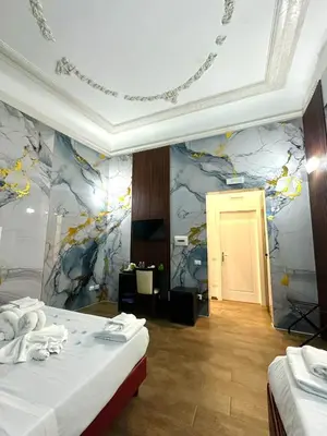 a bedroom with a bed with towels and red lights at Il Tempio Della Capitale in Rome