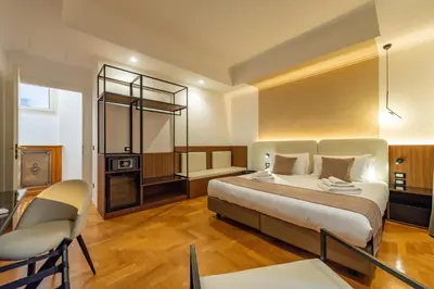a bedroom with a large bed and a table and chair at Relais Pamphili guest house by Ghor in Rome