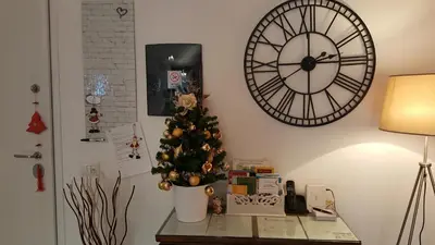 a christmas tree on a table next to a clock at Capone Al Vaticano in Rome