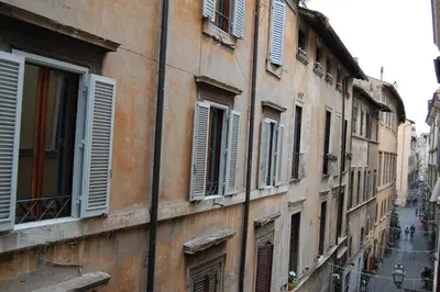 a row of buildings with shuttered windows on a street at Navona Family Apartment in Rome