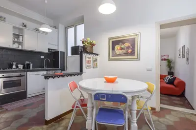 a kitchen with a table and chairs in a room at Navona Family Apartment in Rome