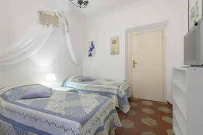 a room with two beds in a room with a door at Navona Family Apartment in Rome