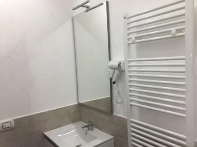 a bathroom with a sink and a mirror at Apartment GLI ARANCI Wohnung by Interhome in Rome