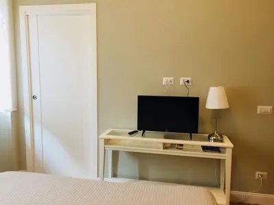 a bedroom with a desk with a television on it at FAIROME Apartment Cassia in Rome