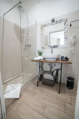 a bathroom with a sink and a shower at Maison Coquette in Rome