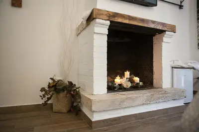 a brick fireplace with candles in a room at Maison Coquette in Rome