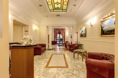 a living room with couches and a stained glass window at Hotel Contilia in Rome