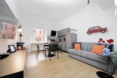 a living room with a couch and a table with a car on the wall at Ricky Bijoux by DomusDimore in Rome