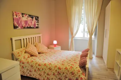 a bedroom with a bed and a window at Alexia Home in Rome
