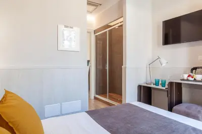 a hotel room with a bed and a television at Residenza Cavallini in Rome