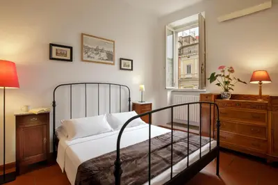 a bedroom with a bed and a dresser and a window at The Right Place 4U Quercia Apartment in Rome