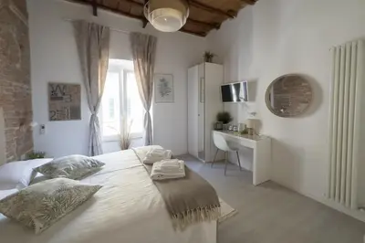 a white bedroom with a bed and a desk at White Ostilia Guesthouse in Rome