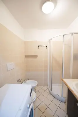 a bathroom with a shower and a toilet and a sink at Grotto Apartment by Campo de Fiori in Rome