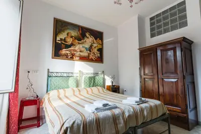 a bedroom with a bed with a painting on the wall at Casavamica in Rome