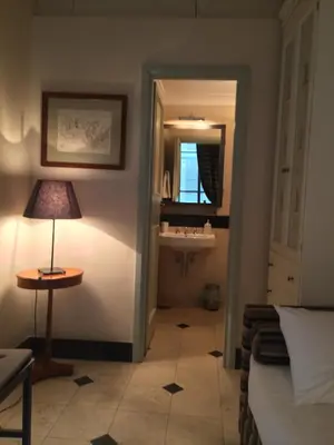 a bathroom with a sink and a table and a lamp at La Casa In Vetrina in Rome