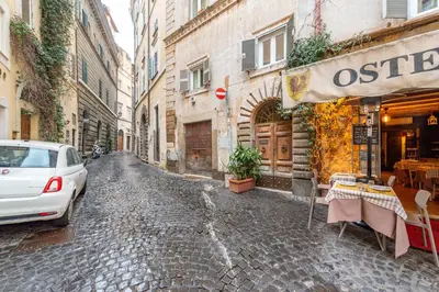 a street with a car parked on a cobblestone street at Shalimar House Navona by Ghor in Rome