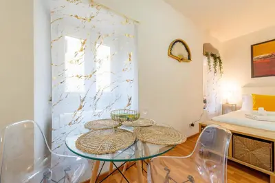 a room with a glass table and chairs and a bed at Shalimar House Navona by Ghor in Rome