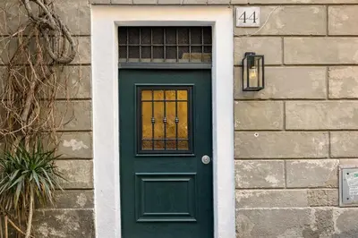 a green door with a window on a building at Studio Coppelle in Rome