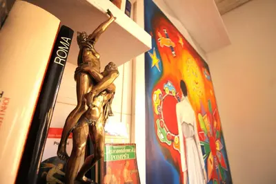 a bronze statue of two people on a shelf at The Trevi Fountain and Spanish Steps Experience in Rome