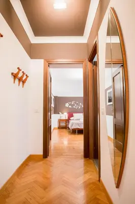a hallway with a mirror and a bed in a room at Polacchi 42 Apartment in Rome