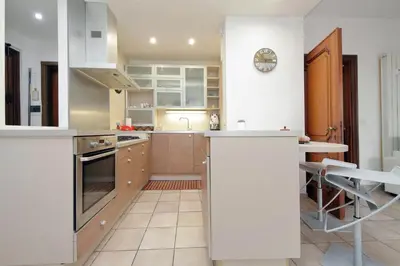 a kitchen with white cabinets and a counter top at 4BNB - Viale Vaticano terrace retreat in Rome