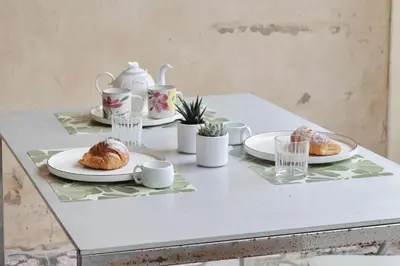 a table with plates of pastries and cups on it at 4BNB - Viale Vaticano terrace retreat in Rome