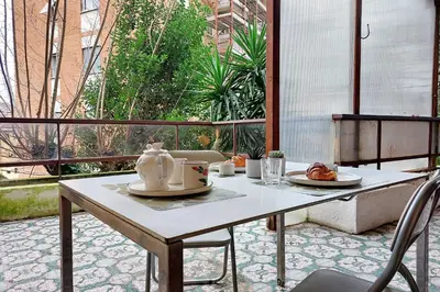 a table with a teapot on it on a patio at 4BNB - Viale Vaticano terrace retreat in Rome