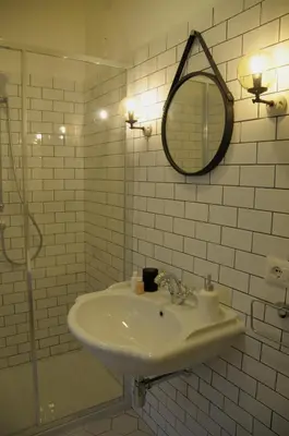 a white bathroom with a sink and a mirror at Guest House Interno4 in Rome