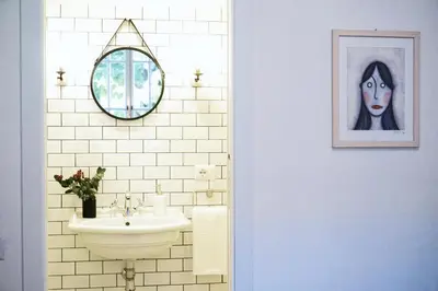 a bathroom with a sink and a picture of a woman at Guest House Interno4 in Rome