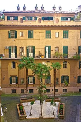 a large building with palm trees in front of it at Guest House Interno4 in Rome