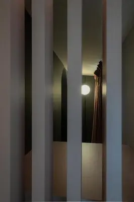 a sliding glass door with a curtain in a room at Colonna Suite Del Corso in Rome