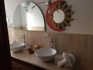 a bathroom with two sinks and a large mirror at B&B La Terrazza in Rome