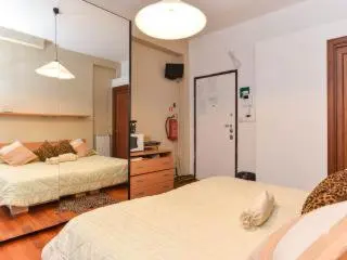 a bedroom with two beds and a mirror at B&B La Terrazza in Rome