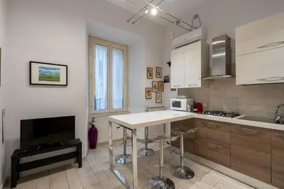 a kitchen with a table and a sink and a microwave at A 20 Gradini dai Musei Vaticani in Rome