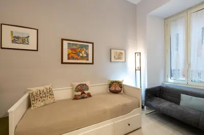 a room with a bed and a couch and a window at A 20 Gradini dai Musei Vaticani in Rome