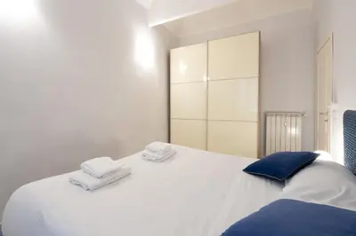 a bedroom with a white bed with towels on it at A 20 Gradini dai Musei Vaticani in Rome