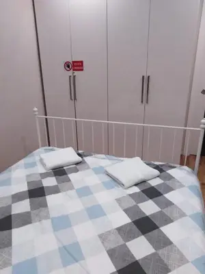 a bedroom with a bed with a checkered floor at YourStay@Rome Coliseum in Rome