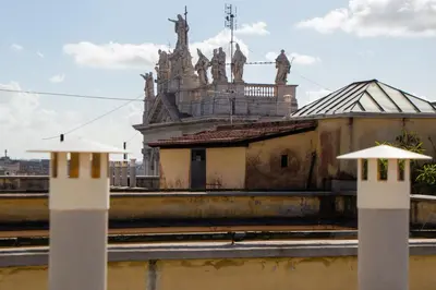 two white posts in front of a building at YourStay@Rome Coliseum in Rome