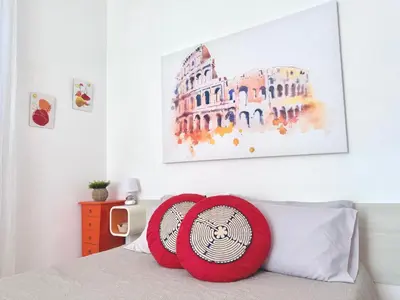 a bedroom with a bed with red pillows and a painting at Apartment Roman Haven by Interhome in Rome