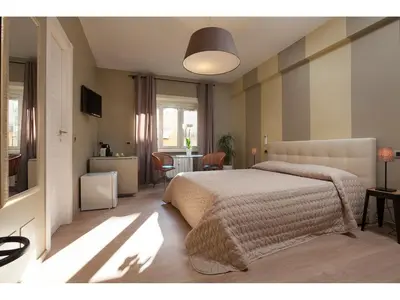 a bedroom with a bed and a dining room with a table at Alex's Guest House in Rome